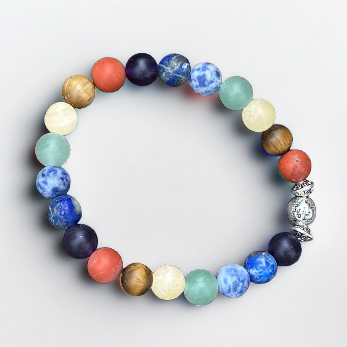 Stretch cord chakra bracelet featuring chakra colors gemstones with Om bead