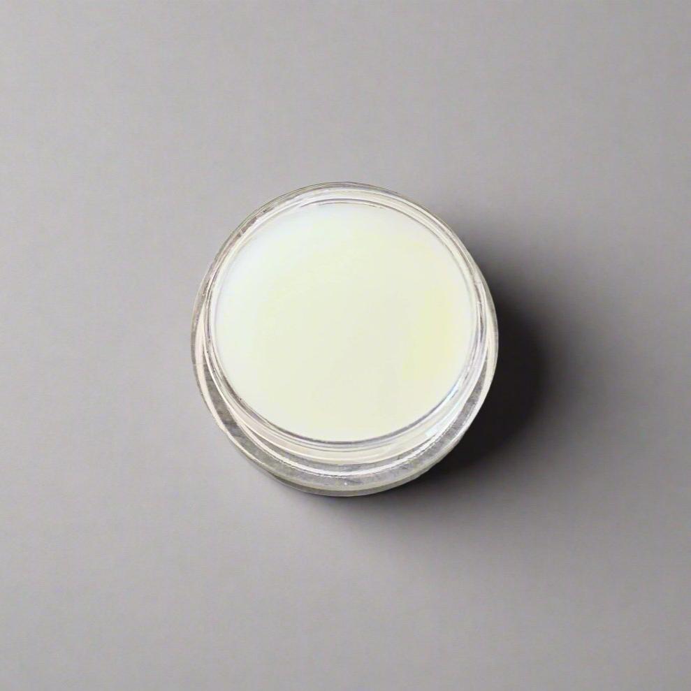  A jar of Ocean Sunrise Lemon Butter Glow Cream with a smooth, creamy texture visible. The jar is clear and is set against a neutral background, showcasing its elegant design.