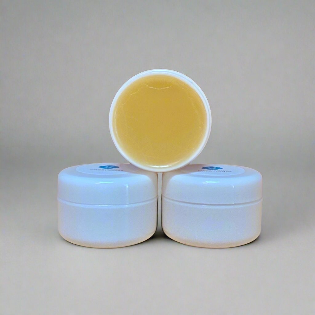 Mini body butters stacked to demonstrate their creamy texture and size