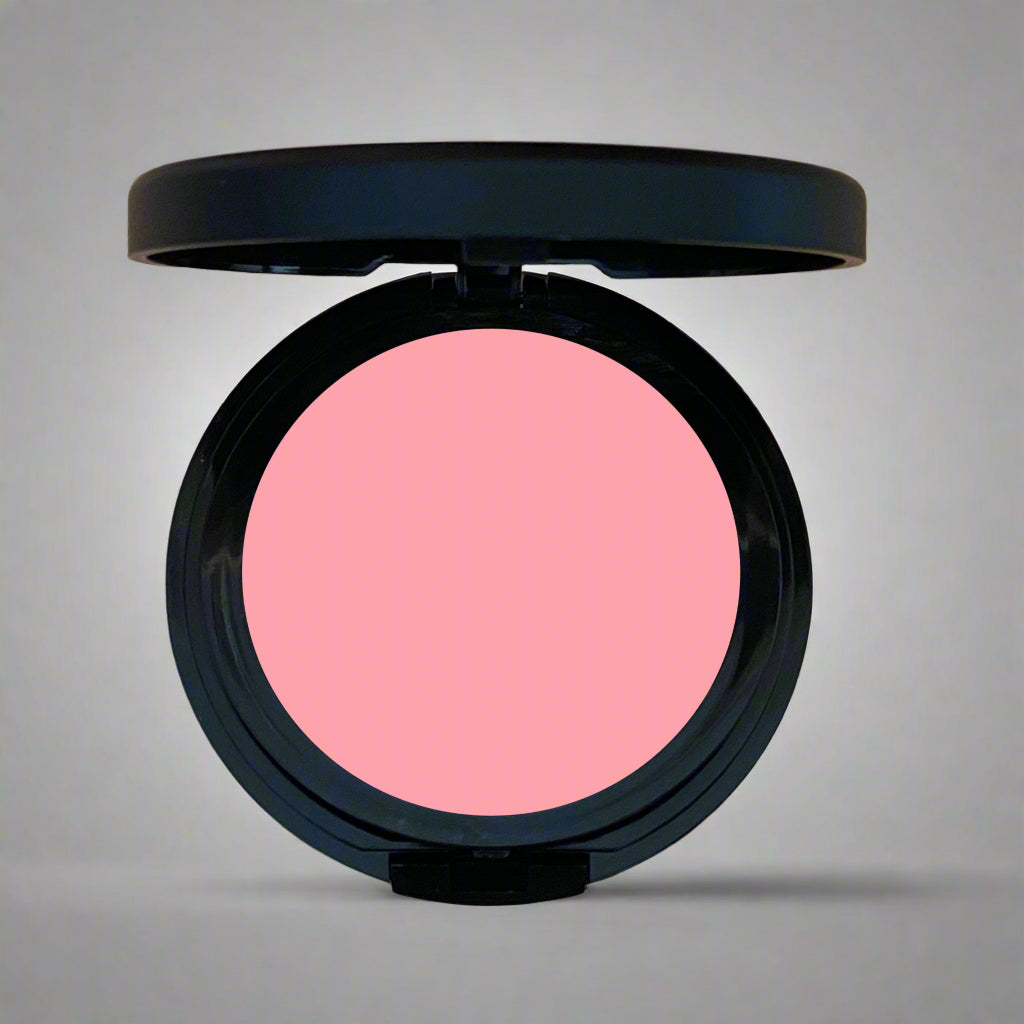 A close-up of Coastal Classic Creations Apricot Matte Blush, a salmon pink shade from the pressed blush line. The blush offers a smooth, matte finish, ideal for a natural, warm glow.