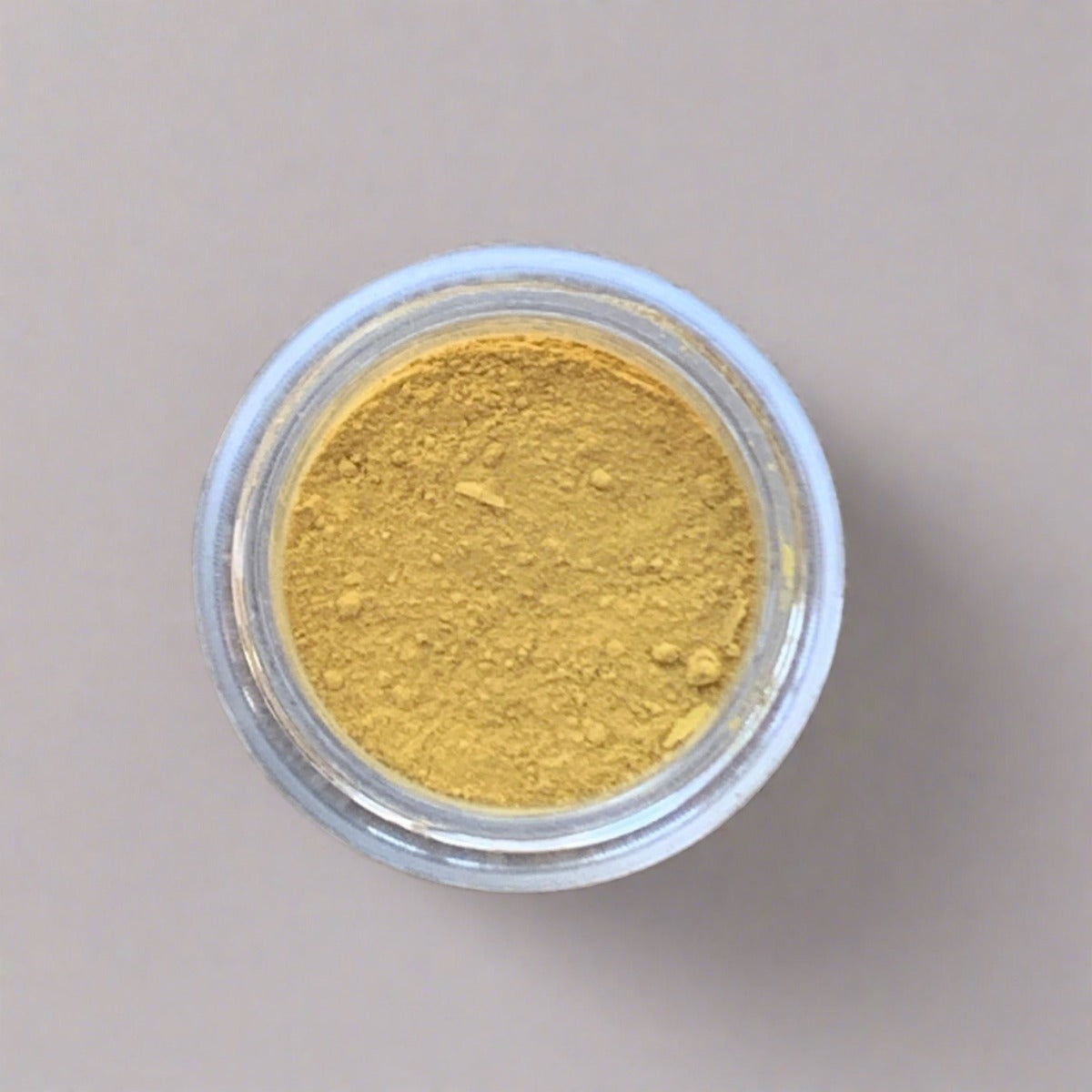 Swatch of light yellow eyeshadow loose powder, displaying its color