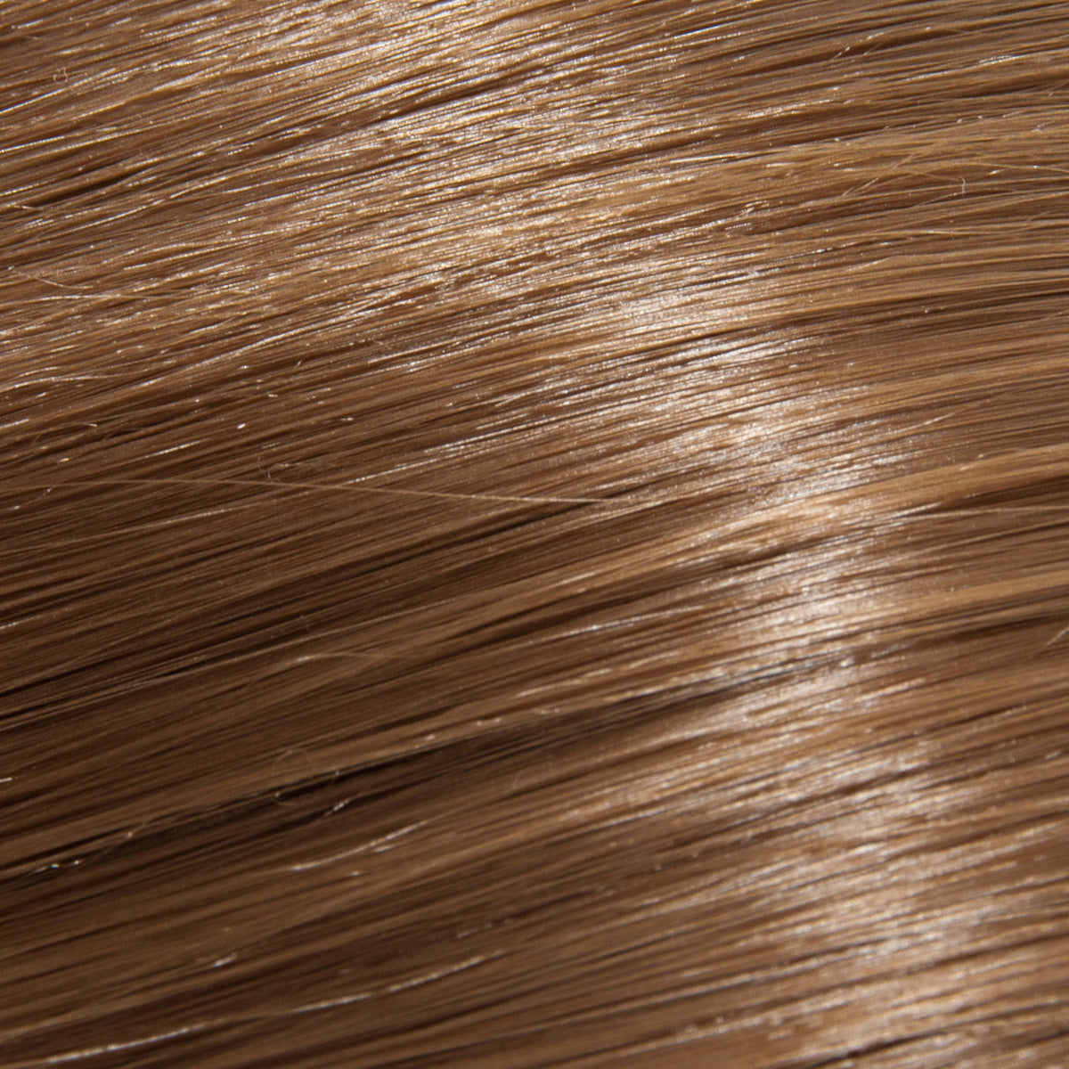 Close-up of hair dyed with blond henna. The hair exhibits a warm, golden blond color with a soft, natural sheen. The texture appears smooth and slightly wavy, showcasing the light, vibrant hue and healthy shine achieved with henna.