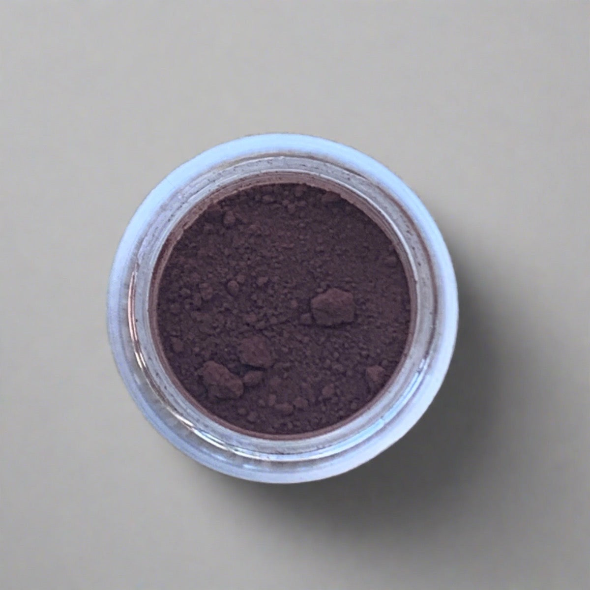 Swatch of purple brown eyeshadow loose powder, displaying its color