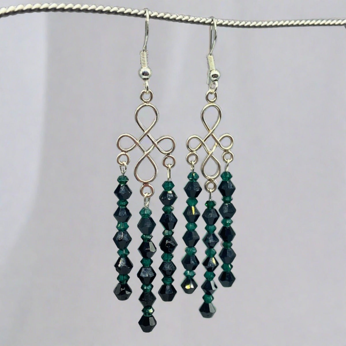 Pair of exquisite green and black chandelier earrings featuring shimmering crystals