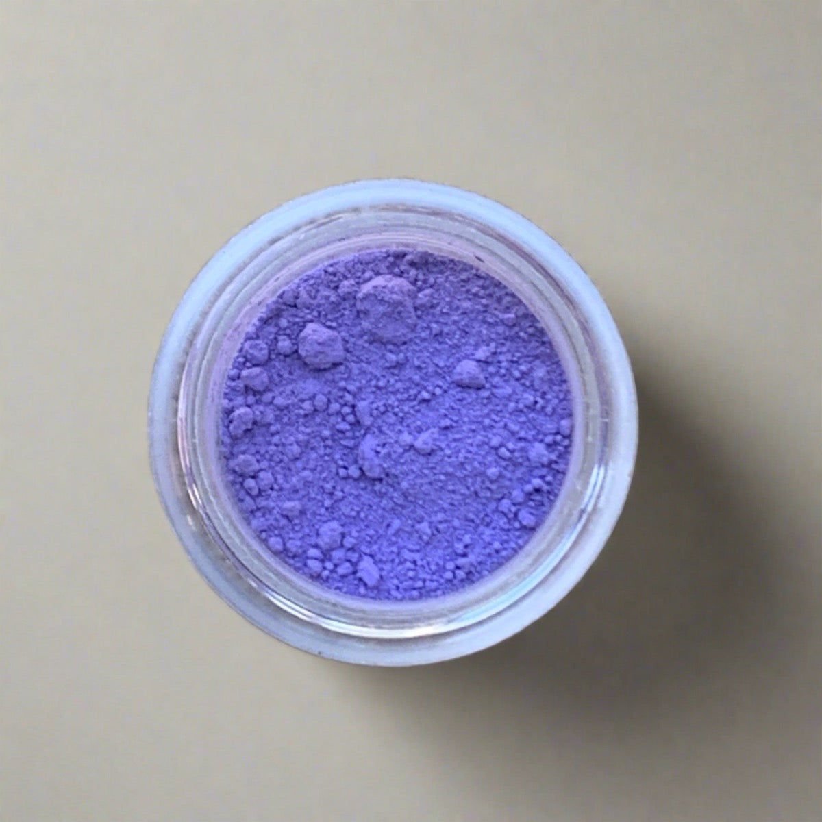 Swatch of lavender blue eyeshadow loose powder, displaying its color