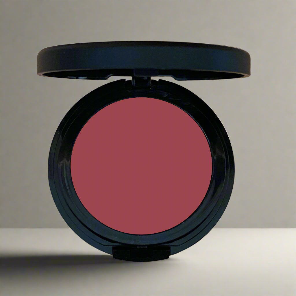 A close-up image of a multi-use cheek and lip tint in sleek, eco-friendly packaging, showcasing its vibrant and creamy formula.