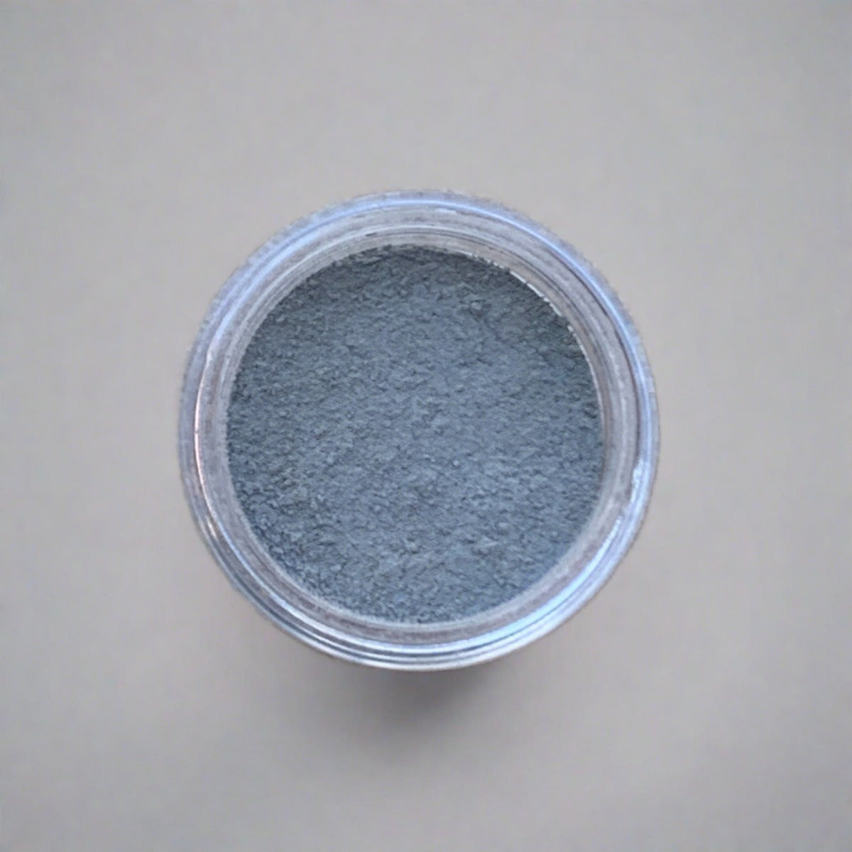 Swatch of light grey eyeshadow loose powder, displaying its color