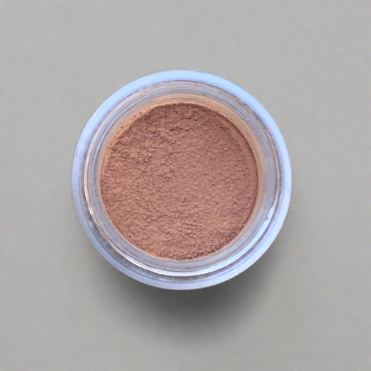 Swatch of warm beige tan eyeshadow loose powder, displaying its color