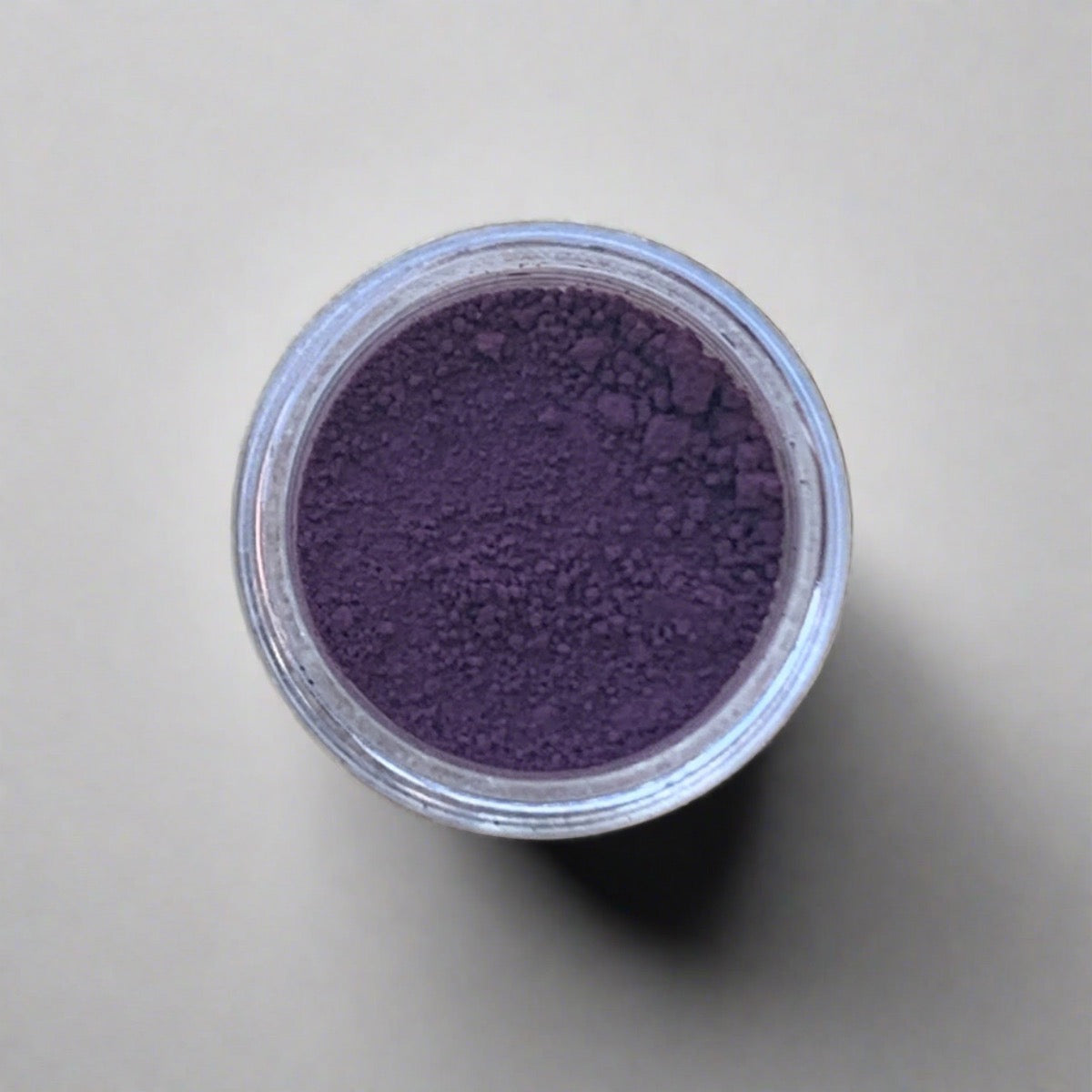 Swatch of deep purple eyeshadow loose powder, displaying its color