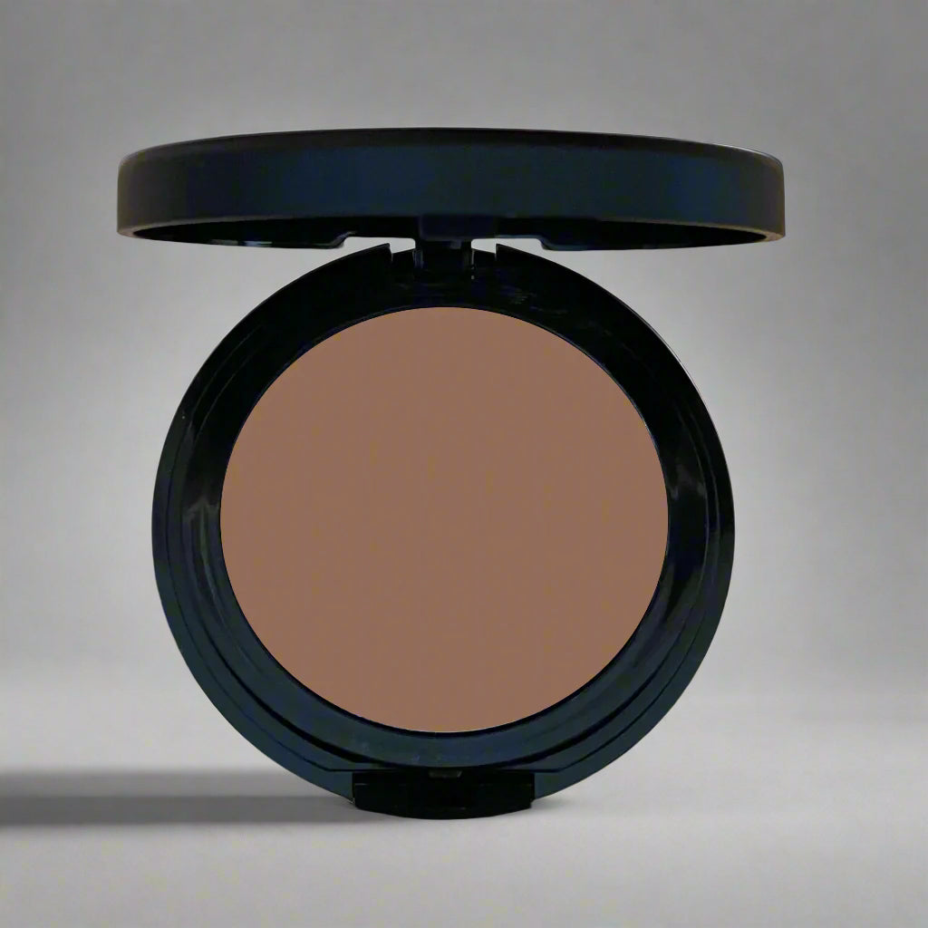 A close-up image of Natural Minerals Foundation Powder in its packaging, showcasing its smooth and lightweight texture.