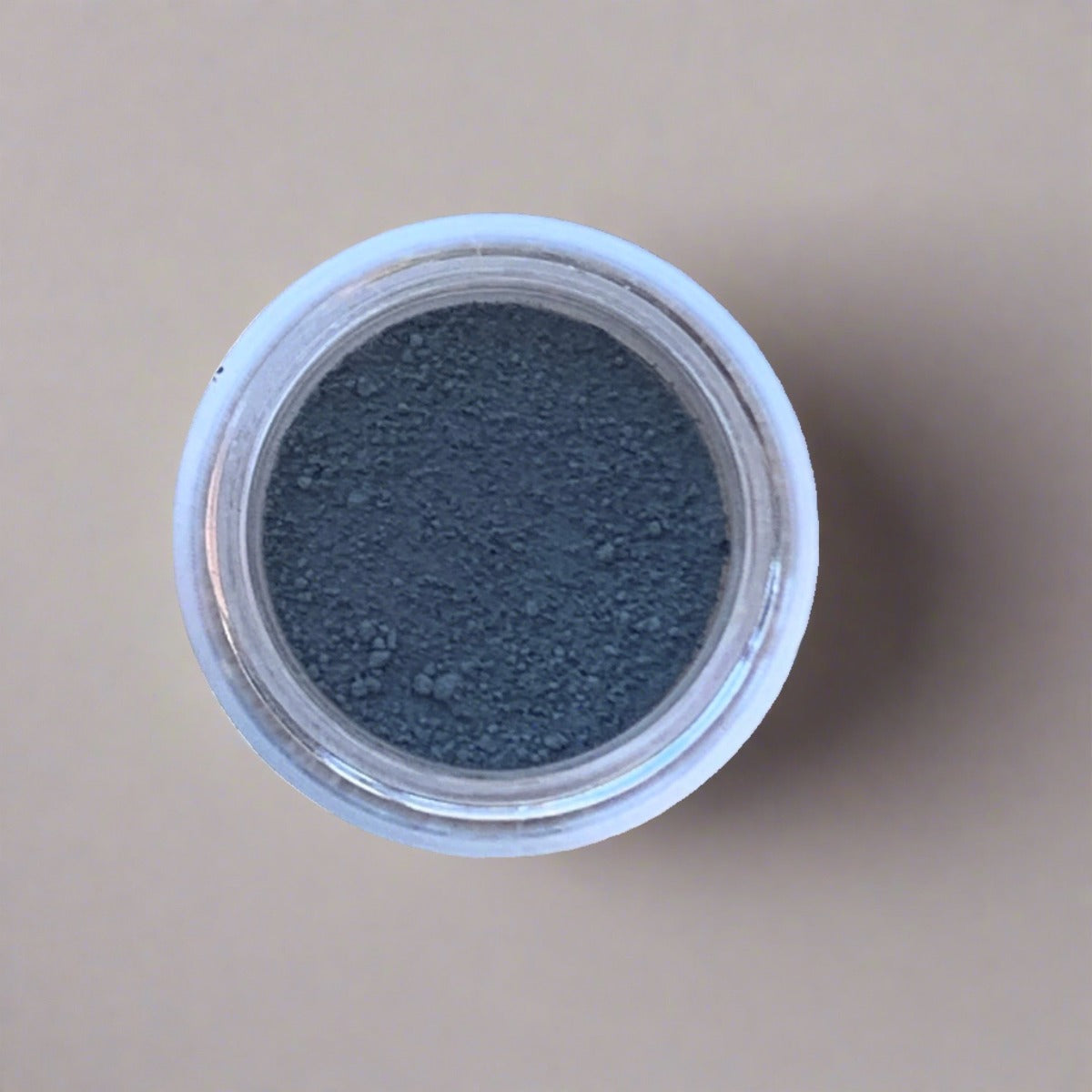 Swatch of smoky grey eyeshadow loose powder, displaying its color